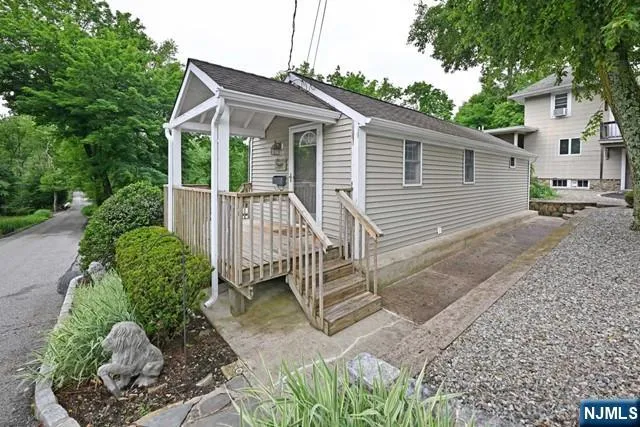 a view of a house with a yard and a garden