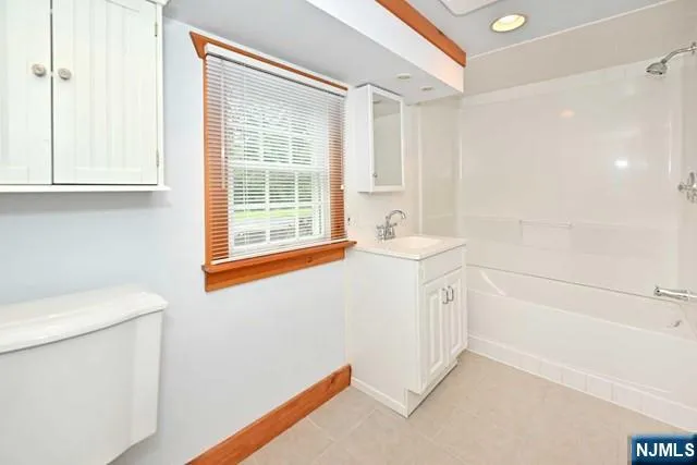 a bathroom with a sink a toilet and a shower