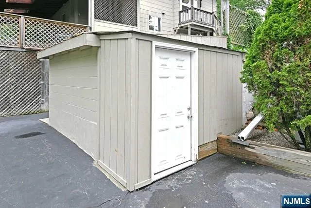 a view of a house with backyard and wooden fence