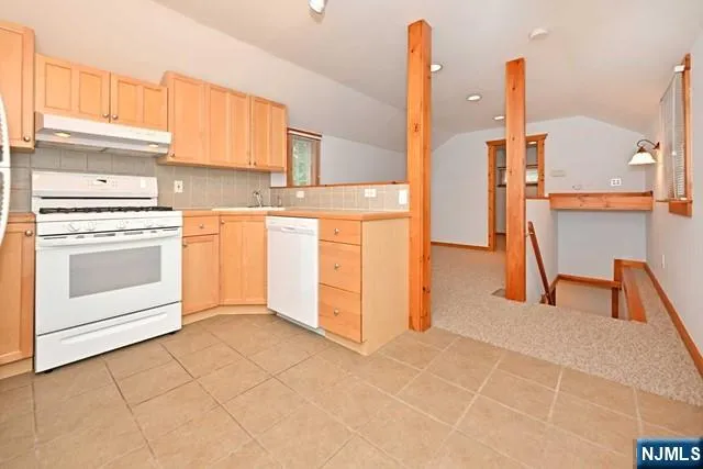a kitchen with stainless steel appliances granite countertop a sink and a stove