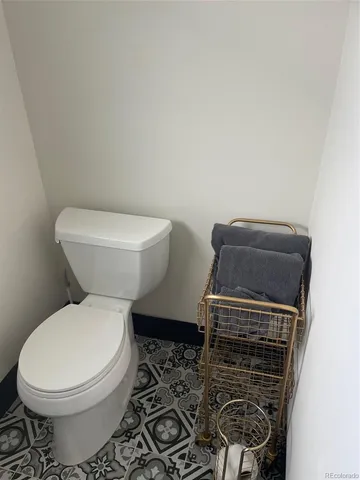 a white toilet sitting next to a sink