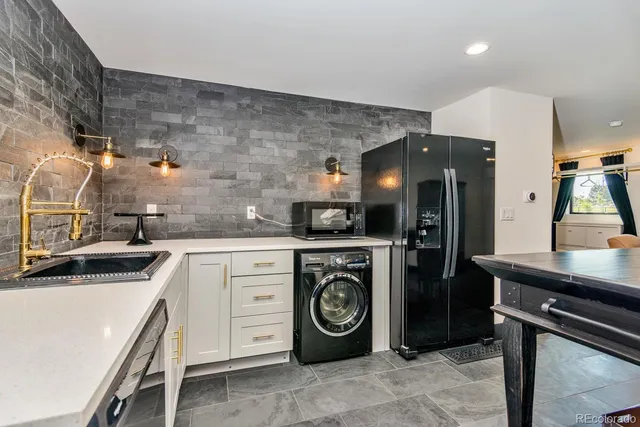 a kitchen with a sink cabinets and stainless steel appliances