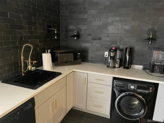 a kitchen with a sink a stove and cabinets