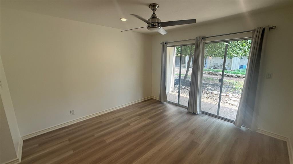 500 East Riverside Drive, Unit 132 Austin, TX 78704 - Photo 9 of 31 a view of an empty room with a window and wooden floor