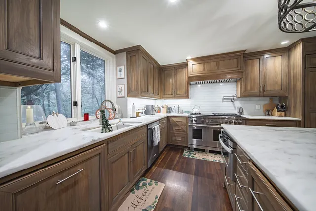 a large kitchen with a stove and a sink