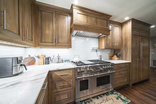 a kitchen with a sink stove and cabinets