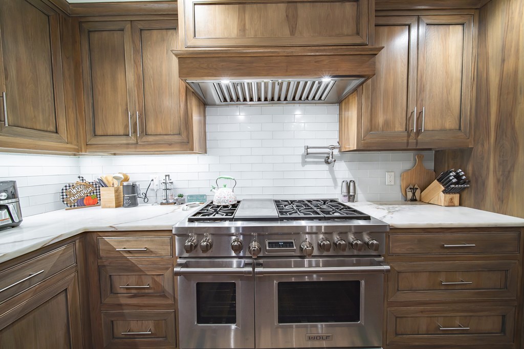 517 Double Churches Road Columbus, GA 31904 - Photo 17 of 96 a kitchen with granite countertop a stove sink and cabinets