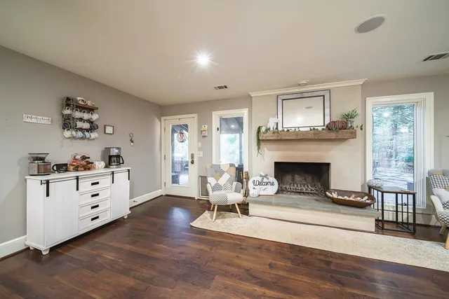 a living room with furniture a fireplace and kitchen view