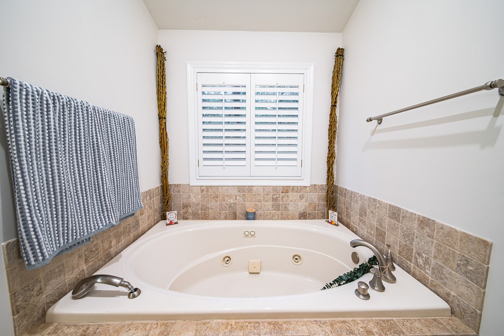 517 Double Churches Road Columbus, GA 31904 - Photo 37 of 96 a bath tub sitting in a bathroom next to a window