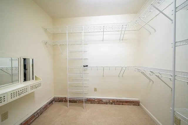 a view of storage and utility room with refrigerator