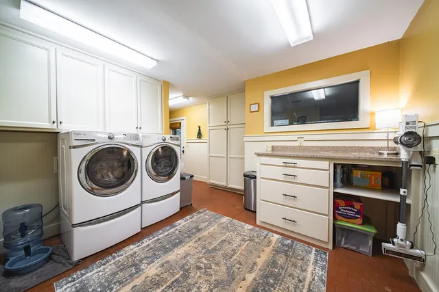 a bedroom with a bed a chair and potted plant on the table
