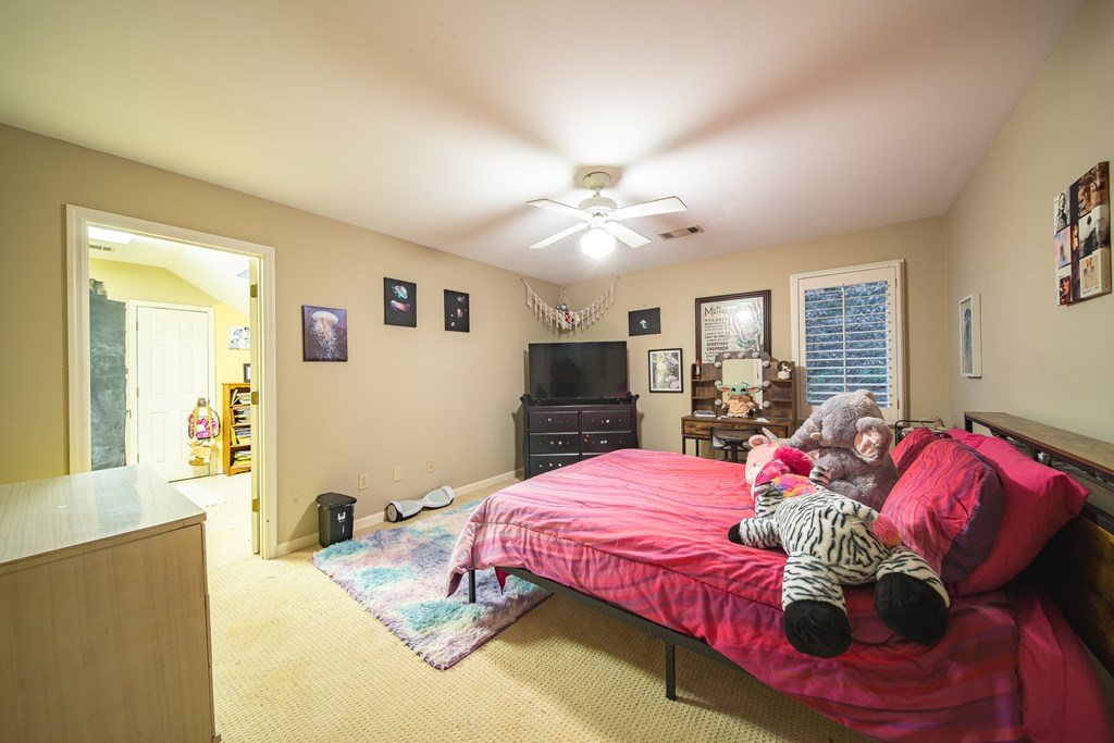 517 Double Churches Road Columbus, GA 31904 - Photo 53 of 96 a bedroom with a bed and dresser with mirror