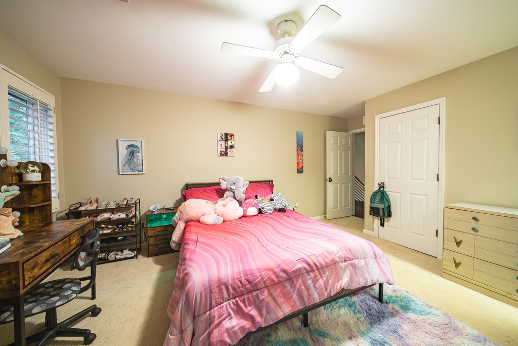 517 Double Churches Road Columbus, GA 31904 - Photo 54 of 96 a bedroom with a bed and a chandelier