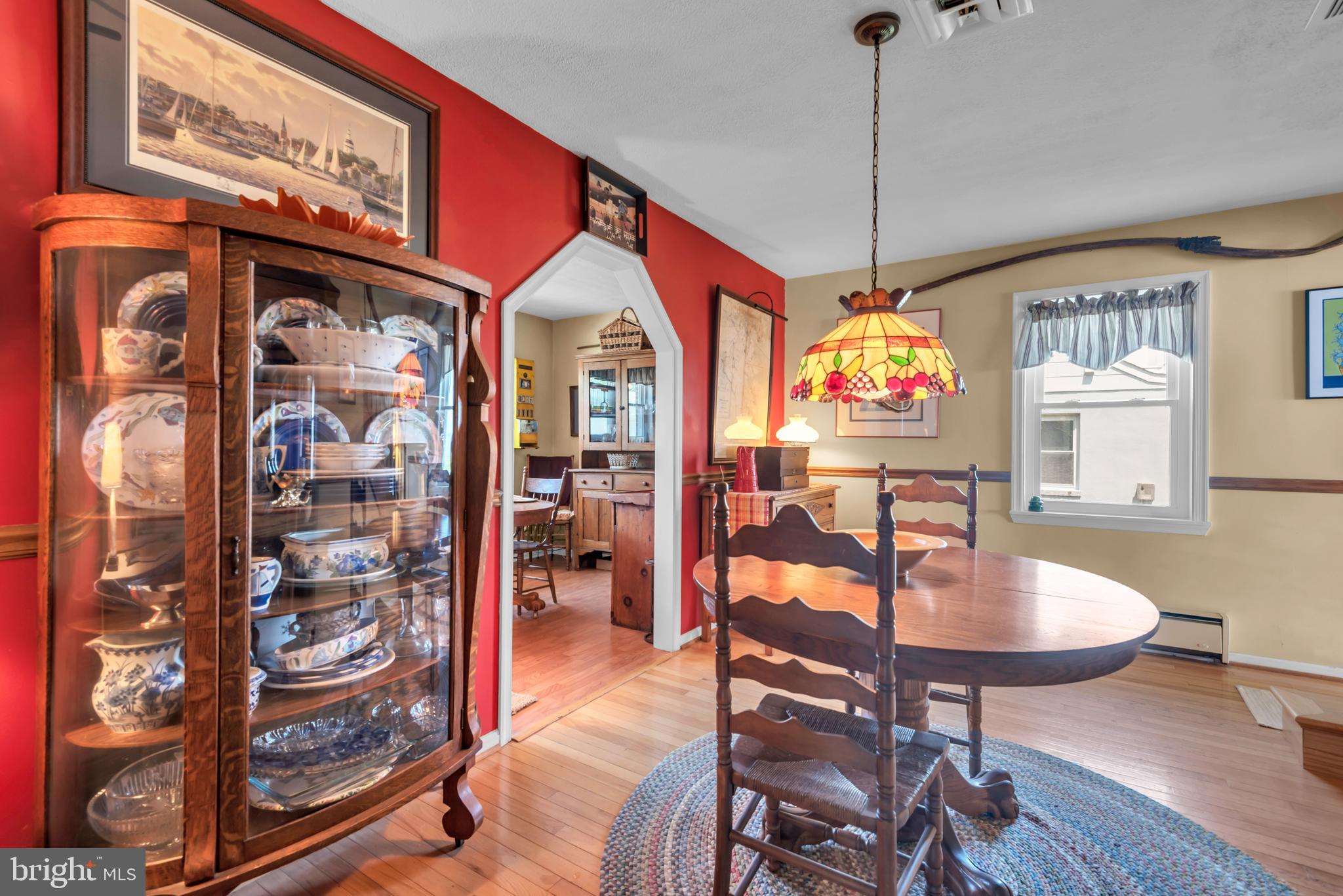 4249 Kings Road Edgewater, MD 21037 - Photo 13 of 54 a dining room with furniture a rug and wooden floor