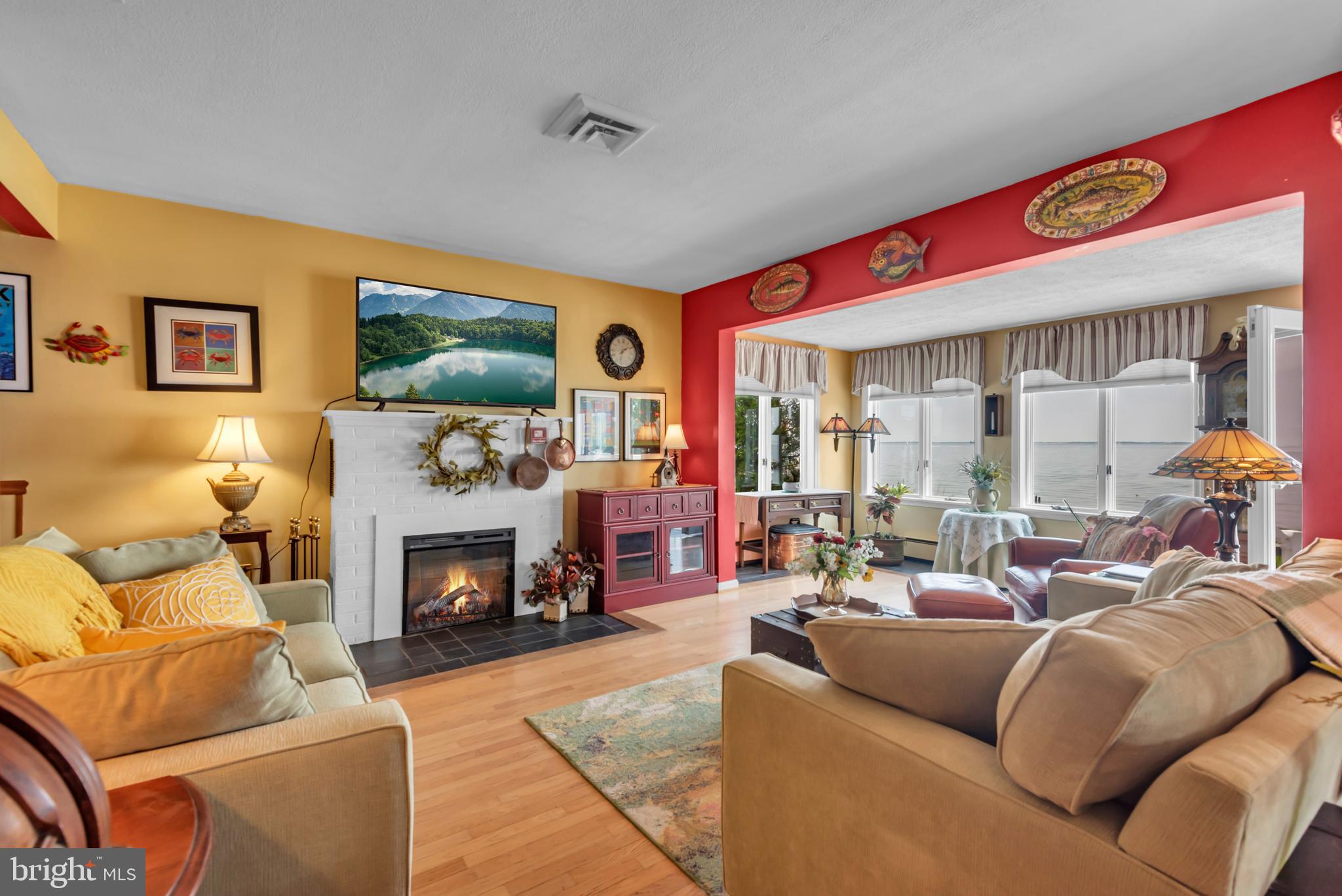 4249 Kings Road Edgewater, MD 21037 - Photo 16 of 54 a living room with furniture a flat screen tv and a fireplace