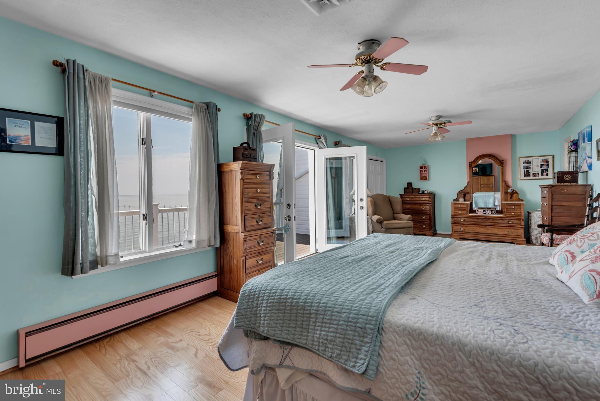 4249 Kings Road Edgewater, MD 21037 - Photo 28 of 54 a bedroom with a large bed and a chandelier