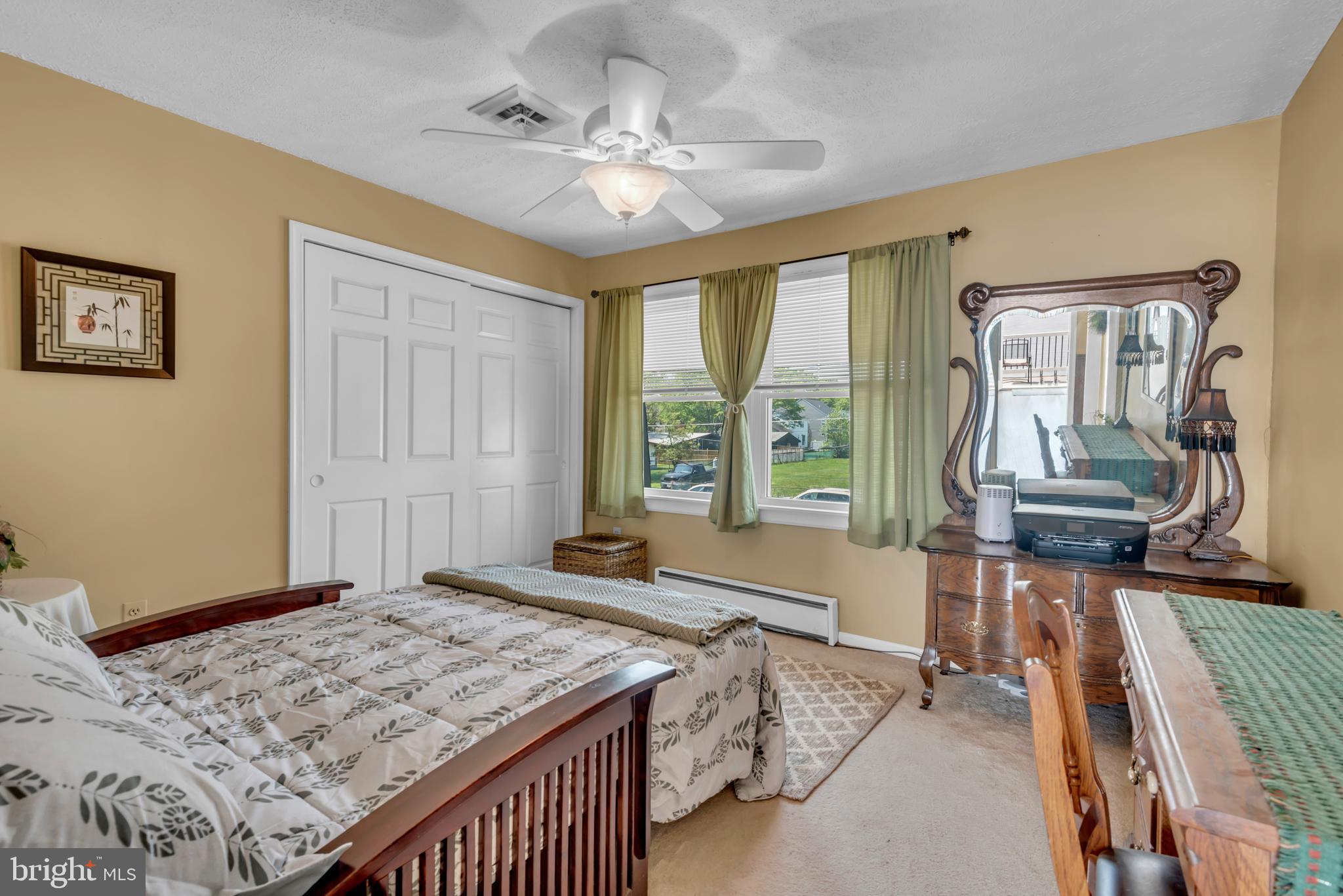 4249 Kings Road Edgewater, MD 21037 - Photo 35 of 54 a spacious bedroom with a bed and a table in it