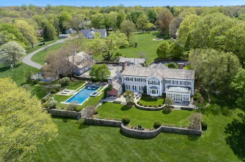 an aerial view of a house with swimming pool outdoor seating and yard