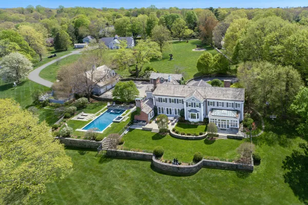 an aerial view of a house with swimming pool outdoor seating and yard