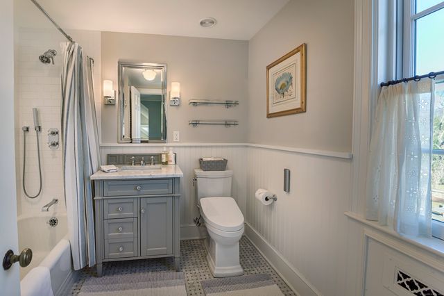 a bathroom with a granite countertop sink toilet and shower