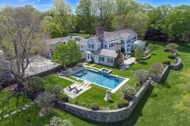 an aerial view of a house with swimming pool outdoor seating yard and mountain view