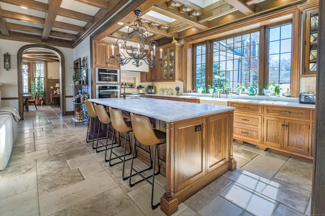 a dining hall with stainless steel appliances granite countertop a stove a sink and a granite counter top