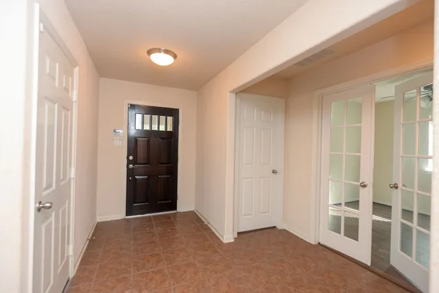 a view of an empty room with a window