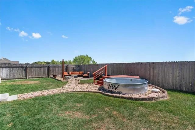 a view of a backyard with sitting area