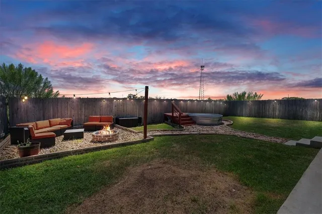 a view of a backyard with sitting area