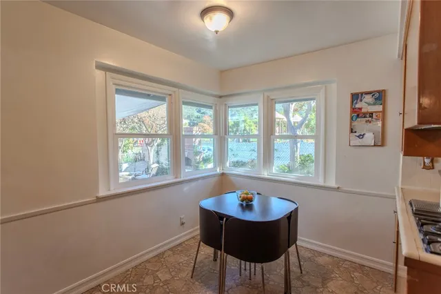 a view of a dining room with a table and chairs
