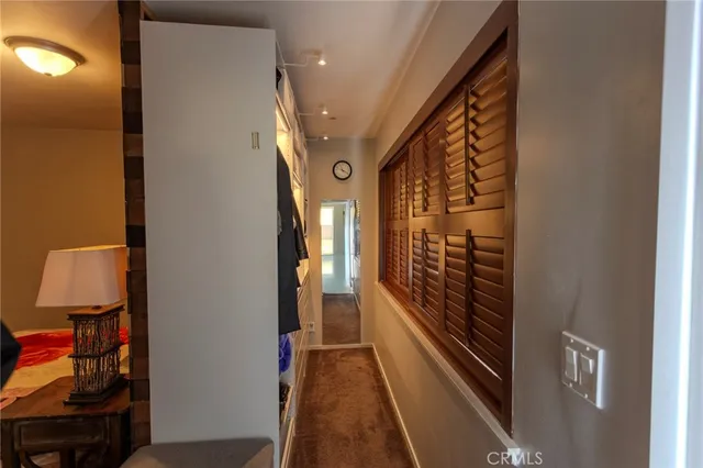 a view of a hallway with wooden floor and entryway