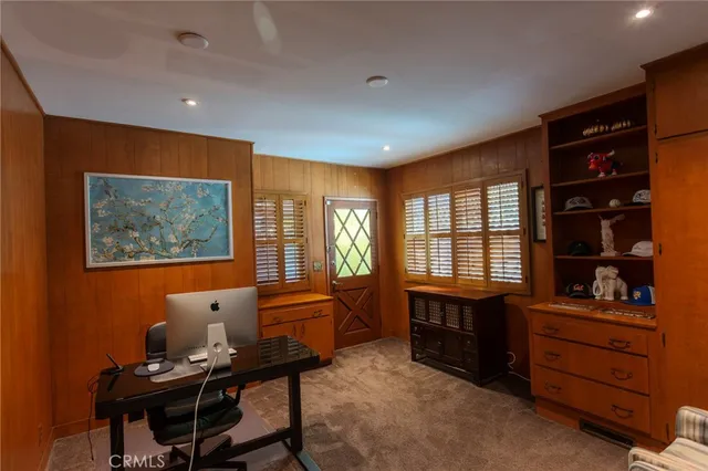 a livingroom with workspace and a window