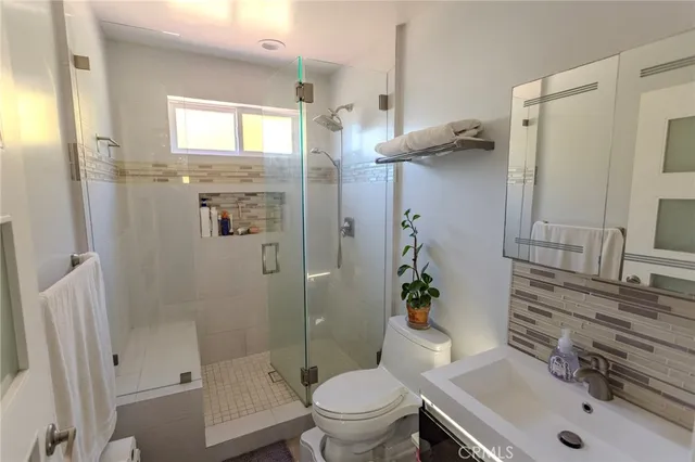 a bathroom with a sink toilet and shower