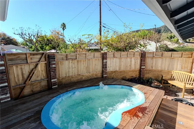 a view of a backyard with swimming pool
