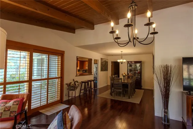 a view of a dining room with furniture wooden floor and chandelier