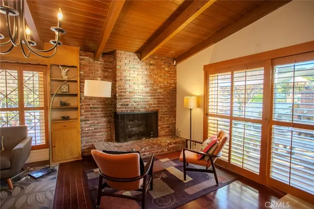 a dining room with furniture and a floor to ceiling window