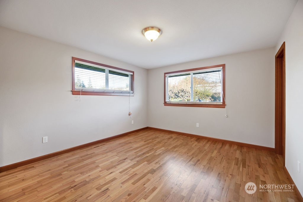 16303 Roosevelt Road Snohomish, WA 98290 - Photo 14 of 36 a view of an empty room with wooden floor and a window