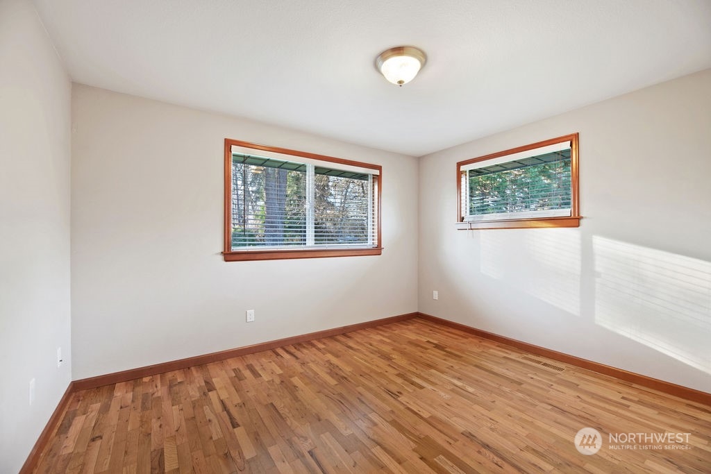 16303 Roosevelt Road Snohomish, WA 98290 - Photo 19 of 36 a view of an empty room with wooden floor and a window