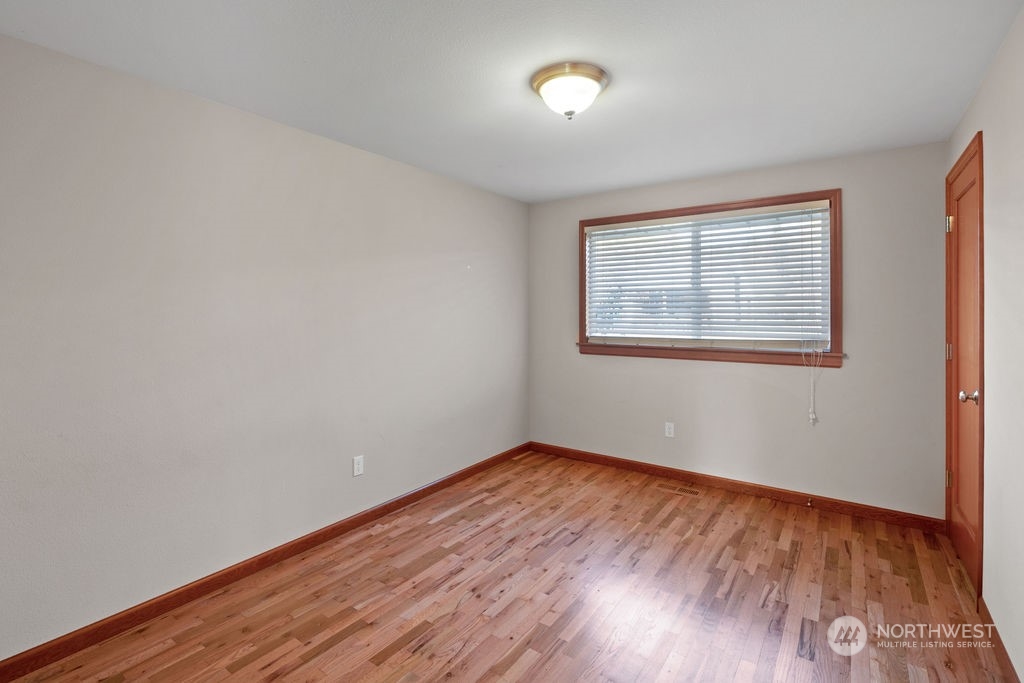 16303 Roosevelt Road Snohomish, WA 98290 - Photo 20 of 36 a view of an empty room with wooden floor and a window