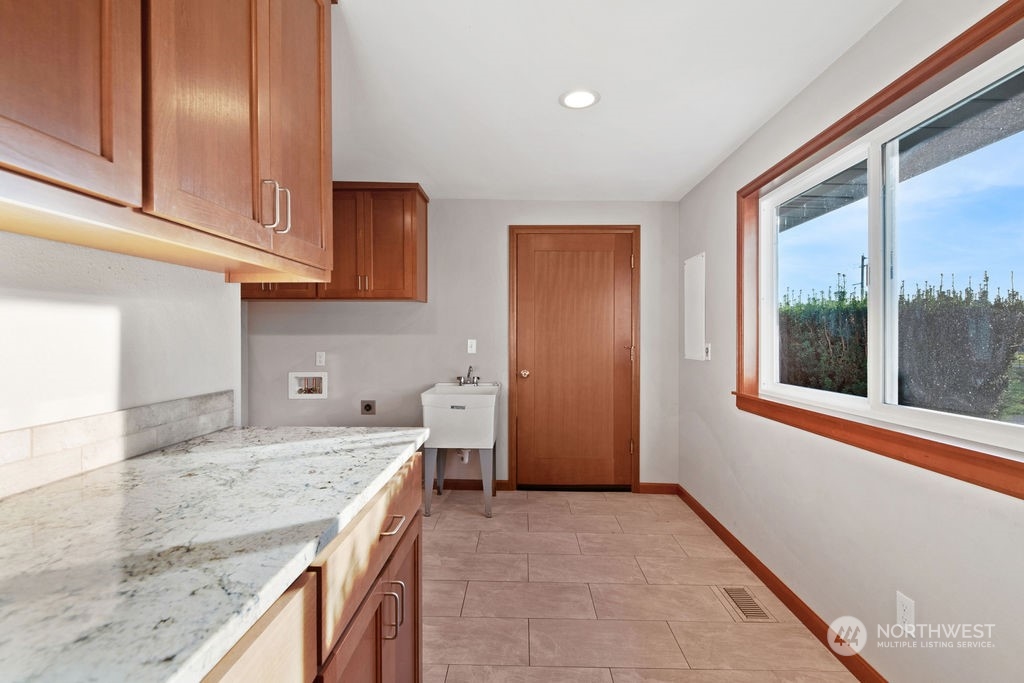 16303 Roosevelt Road Snohomish, WA 98290 - Photo 21 of 36 a kitchen with granite countertop sink and cabinets