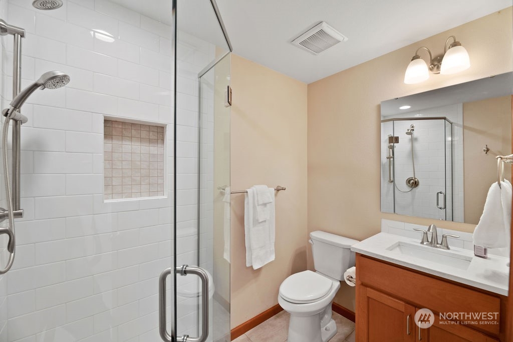 16303 Roosevelt Road Snohomish, WA 98290 - Photo 23 of 36 a bathroom with a granite countertop toilet sink and shower
