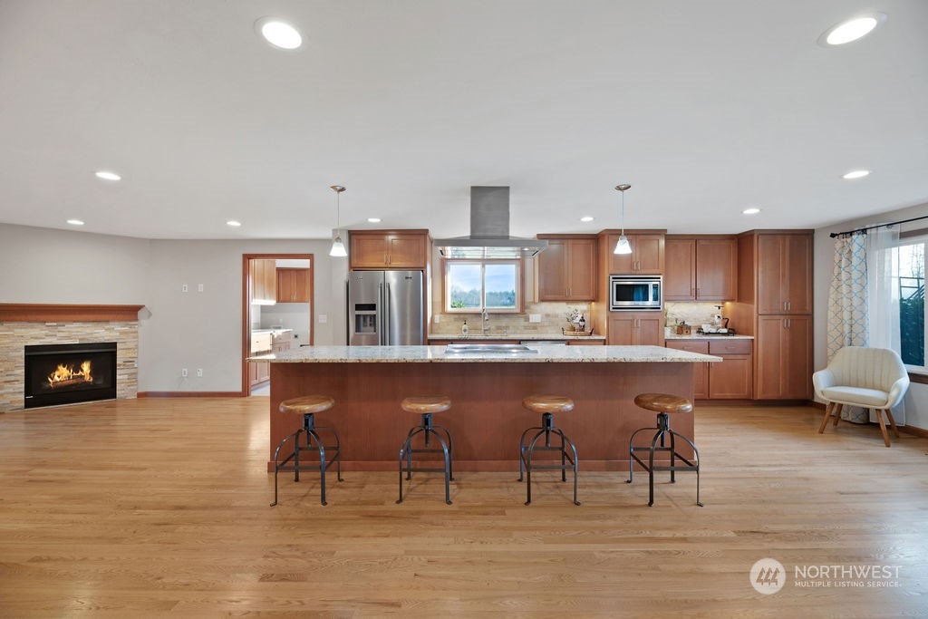 16303 Roosevelt Road Snohomish, WA 98290 - Photo 5 of 36 a open kitchen with stainless steel appliances granite countertop a table chairs sink and cabinets