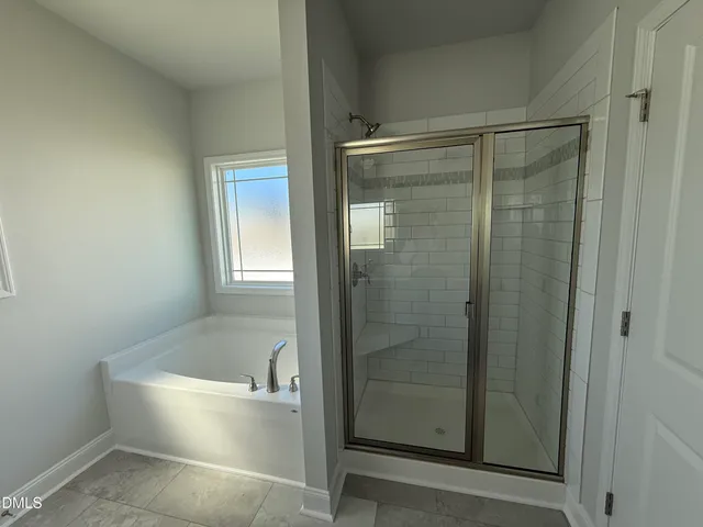 a bathroom with a bathtub and a shower