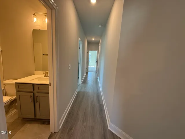 a view of a hallway with wooden floor