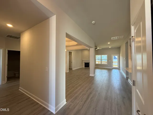 a view of hallway with wooden floor