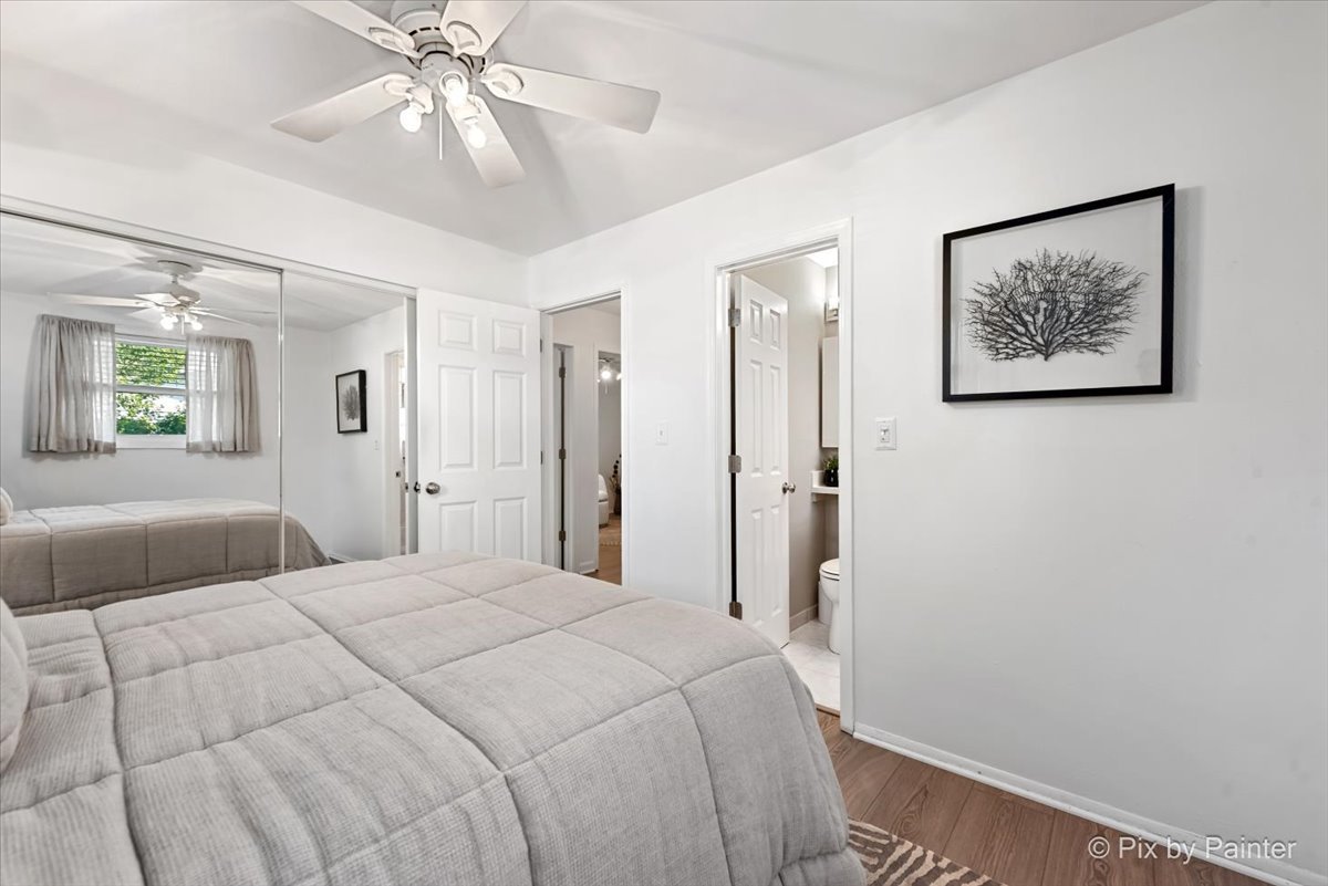 712 Aztec Drive Carol Stream, IL 60188 - Photo 20 of 40 a bedroom with a large bed and a chandelier