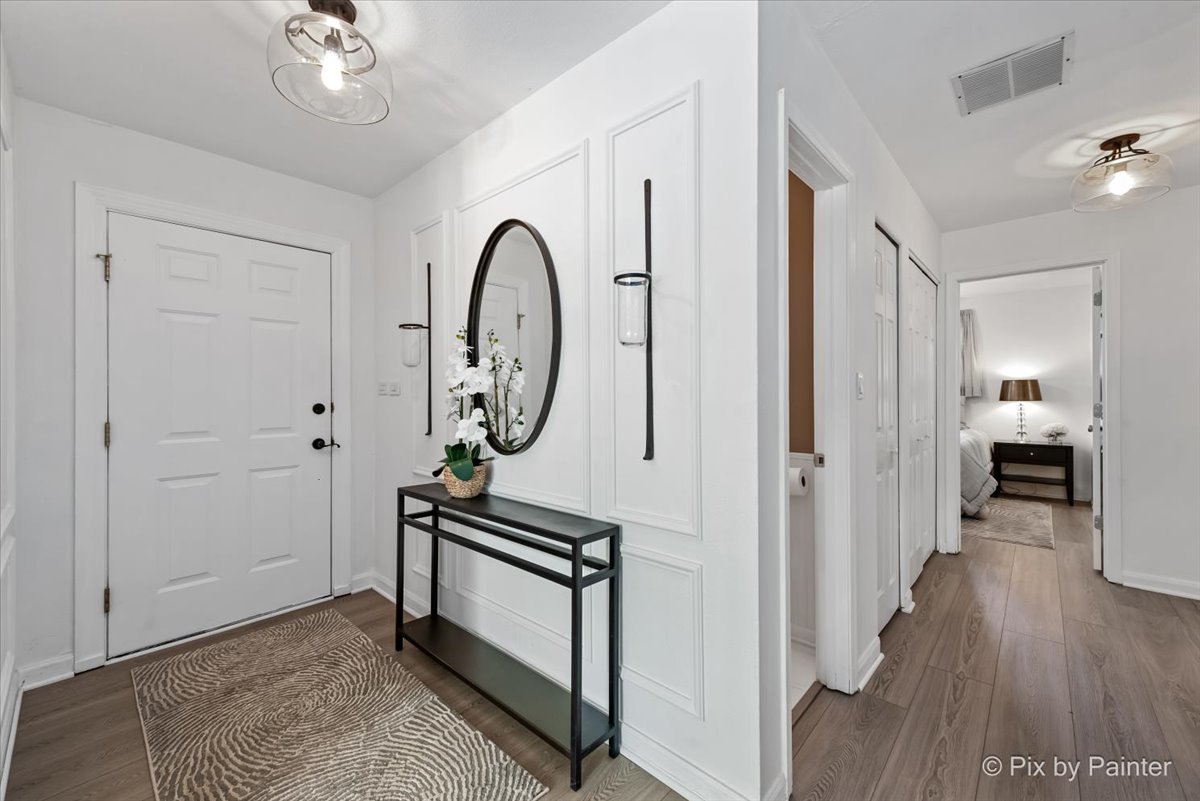 712 Aztec Drive Carol Stream, IL 60188 - Photo 4 of 40 a view of a hallway with wooden floor and staircase