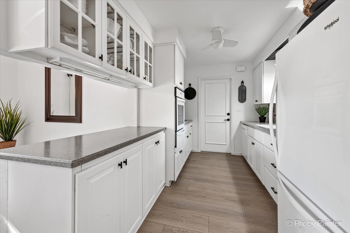 712 Aztec Drive Carol Stream, IL 60188 - Photo 6 of 40 a kitchen with white cabinets and white appliances
