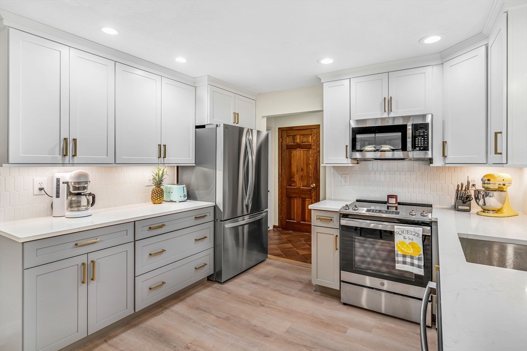 11 Green Needles Road Littleton, MA 01460 - Photo 3 of 41 a kitchen with stainless steel appliances granite countertop a stove a refrigerator and a microwave