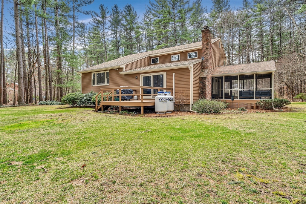 11 Green Needles Road Littleton, MA 01460 - Photo 36 of 41 a front view of a house with garden and trees
